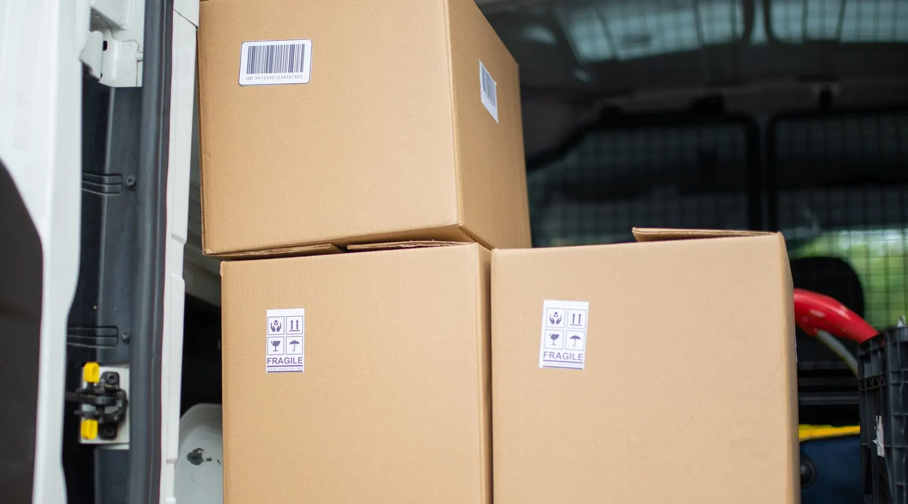 Stacked cardboard parcels loaded and ready inside a delivery van