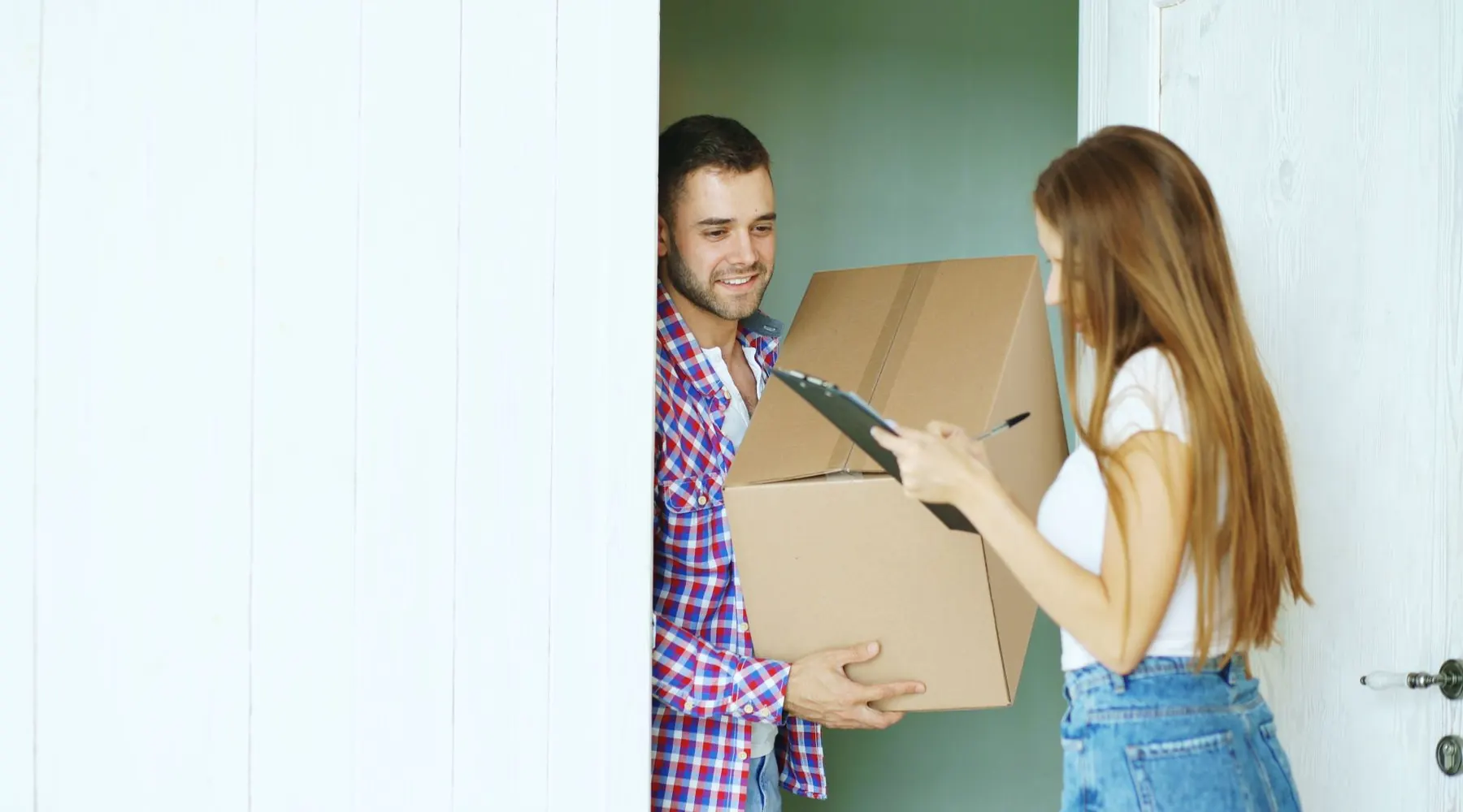 Courier handing a parcel to a customer at their front door