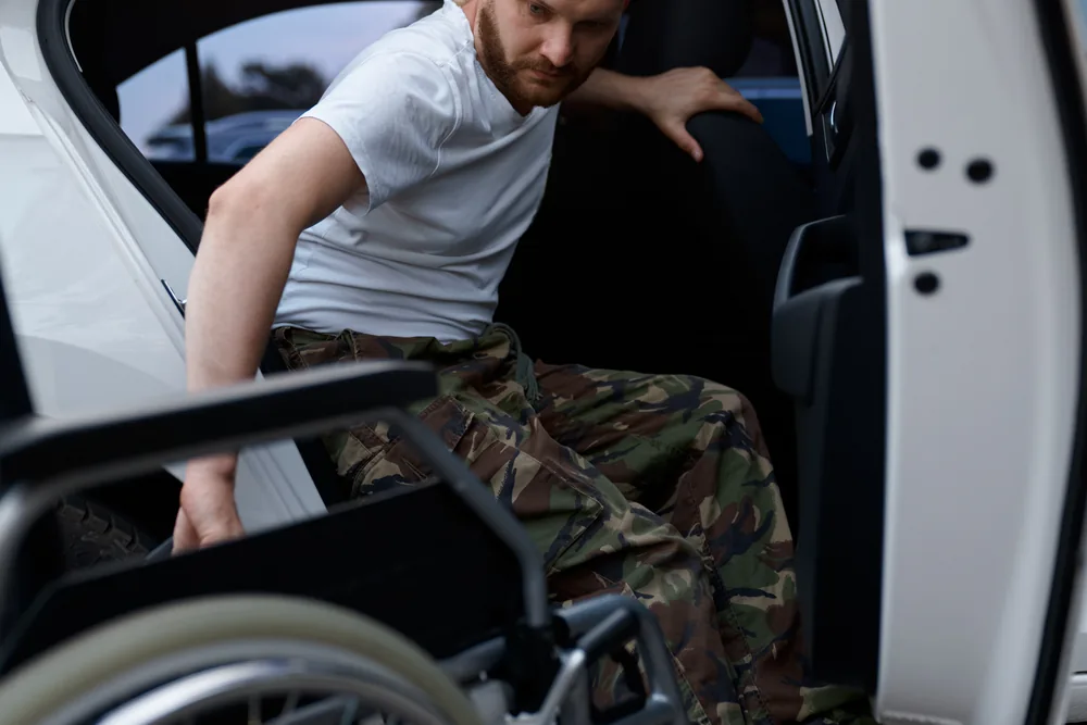 A passenger transferring from a Captain Taxis accessible vehicle into his own wheelchair